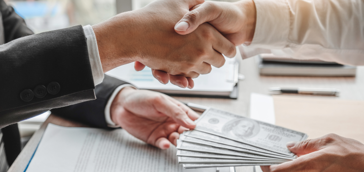 Shaking Hands While Giving $100 Bills