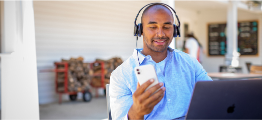 Man with Headphones Using a Phone