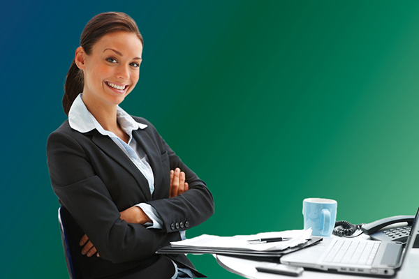 business woman at desk with laptop