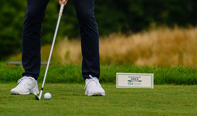person teeing off