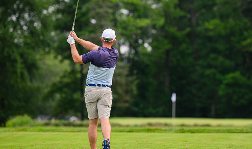 Golfer chipping up to green