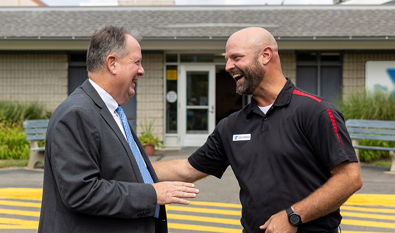 Businessman talking with a GSB banker, outside of a building