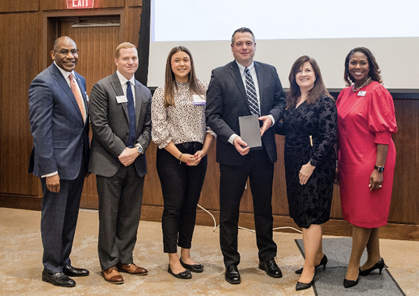 Six people standing for photo, as GSB receives Greenleaf award for servant leadership
