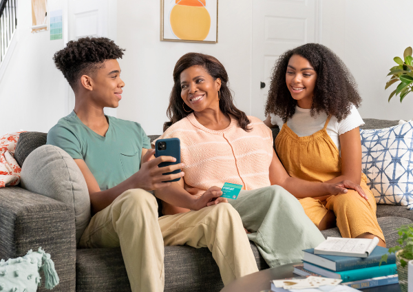 Mom smiling with son and daughter using greenlight app