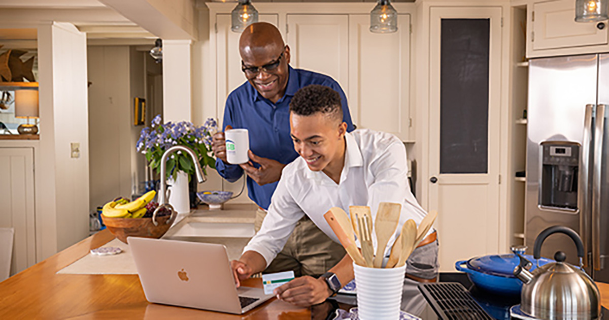 Father and son using a debit card online