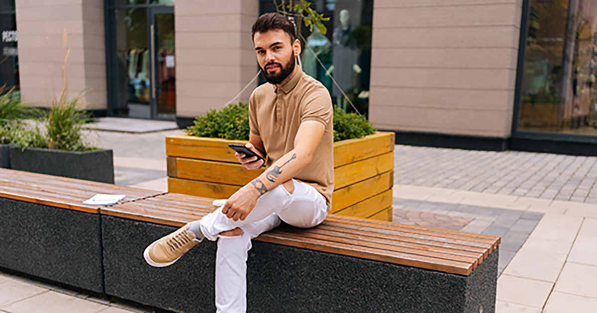Young man sitting on a bench