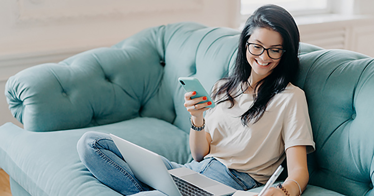 Woman working on her finances on couch