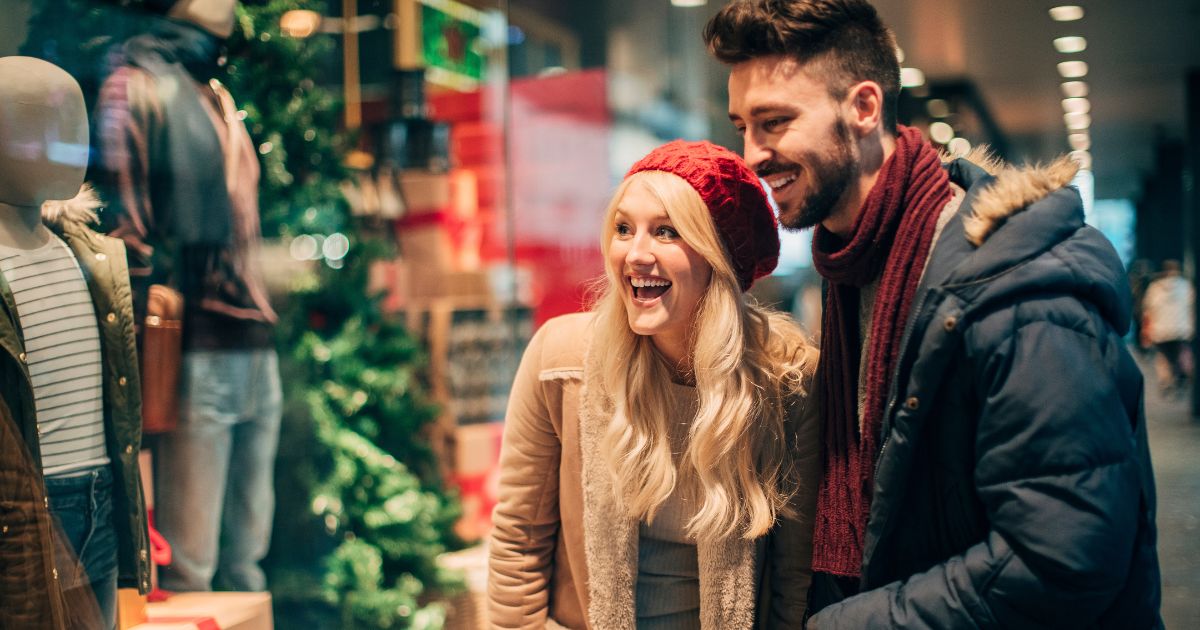 Woman and man couple window shopping in cold weather.