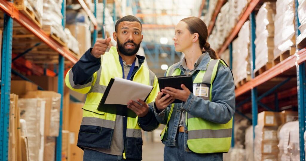 Man and woman working as staff in a stock warehouse.
