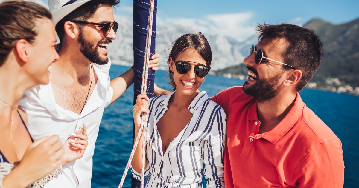 Four friends laughing on a boat.